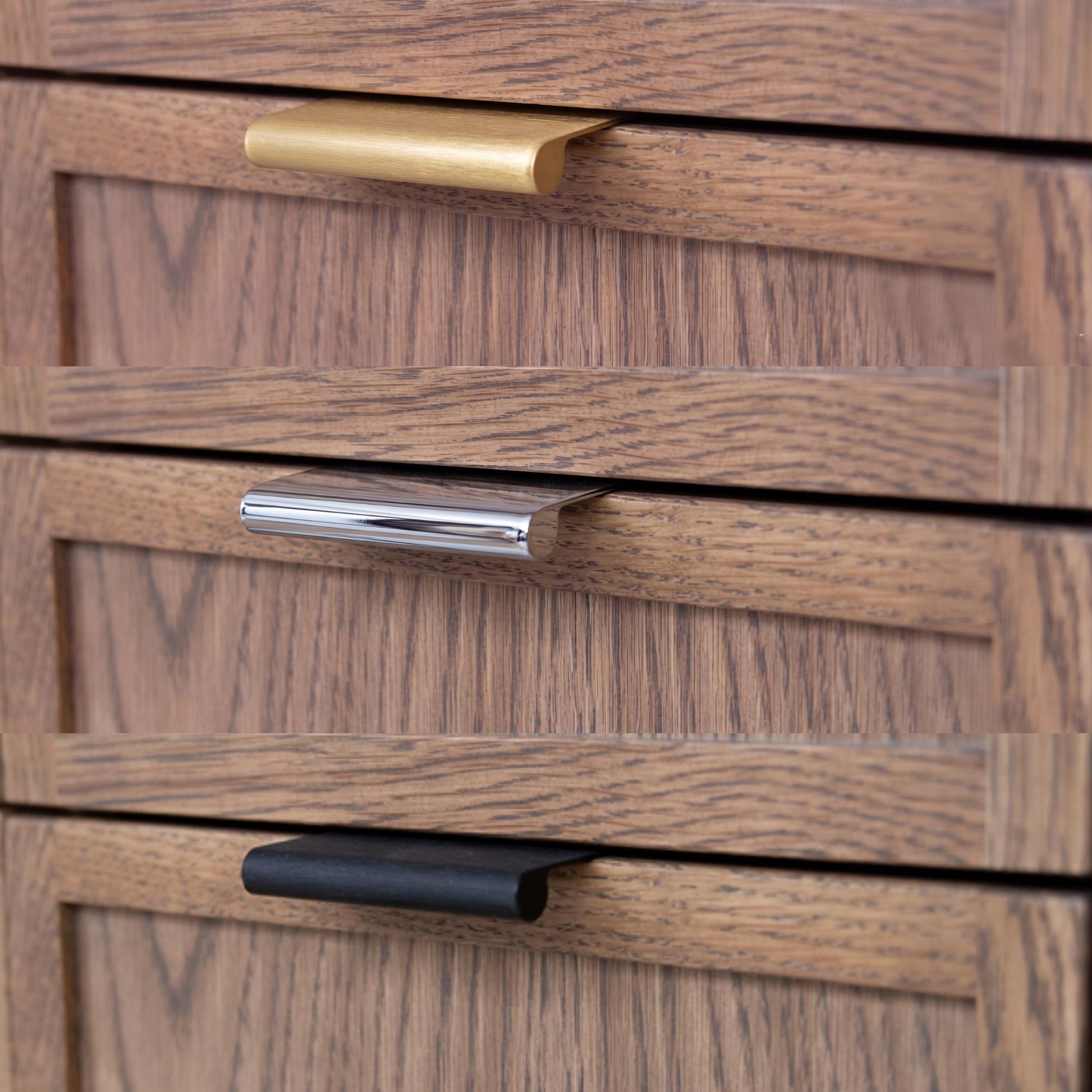Close-up of wooden drawers with gold, silver, and black handles.
