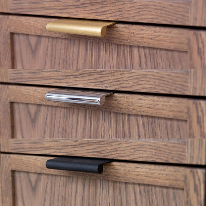 Close-up of wooden drawers with gold, silver, and black handles.