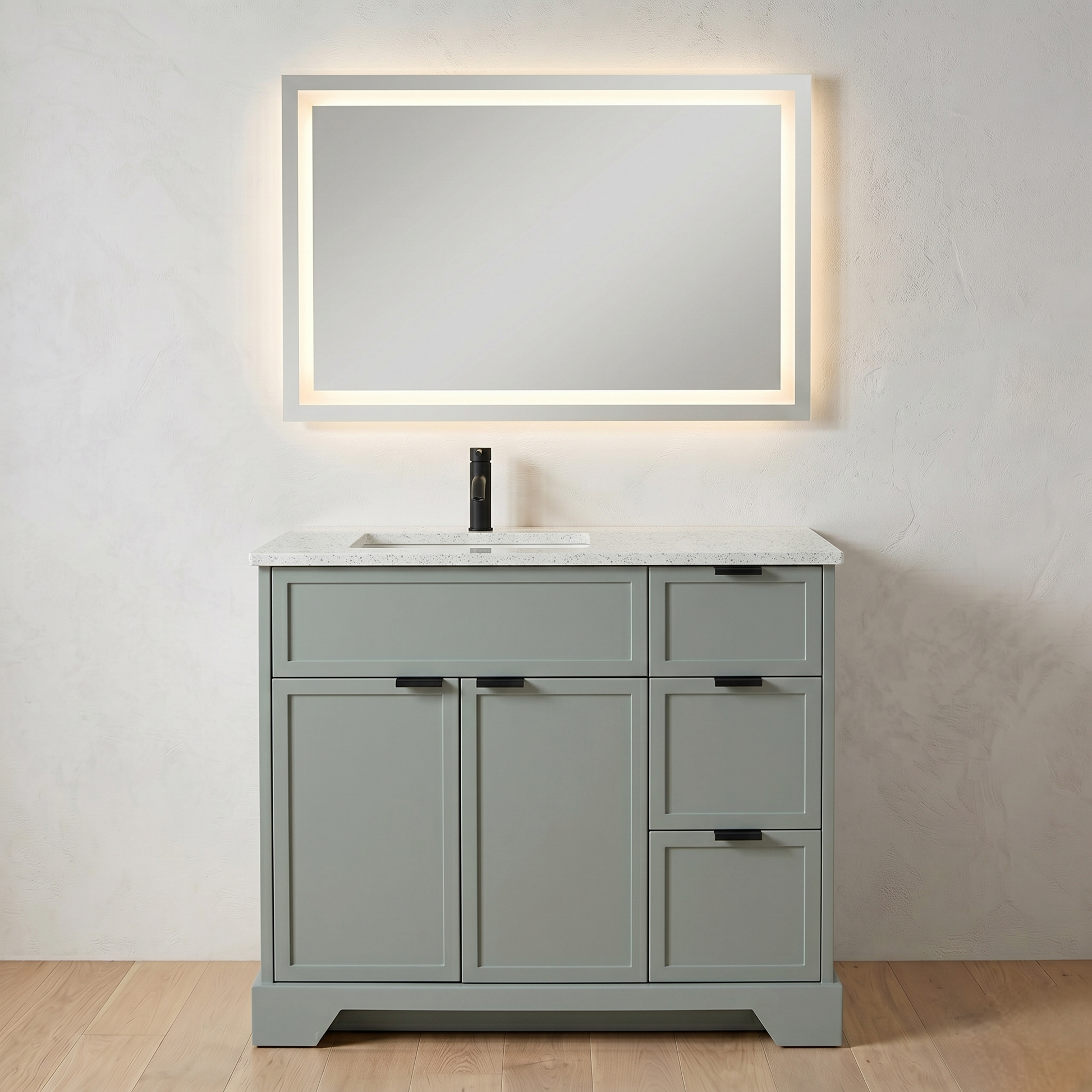 Gray bathroom vanity with white countertop and illuminated mirror on a light gray wall.