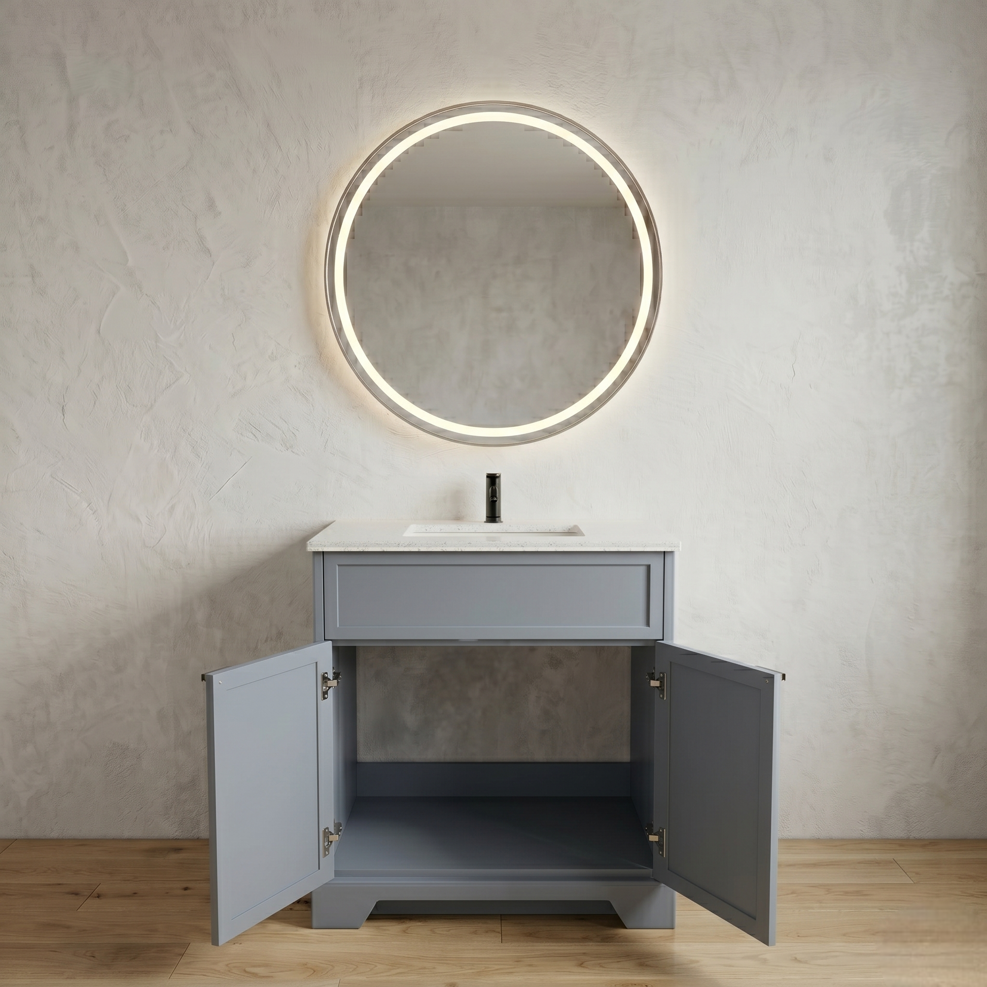 Gray vanity with open doors, round illuminated mirror, and white countertop against a neutral wall.