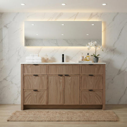 Bathroom vanity with wooden cabinets, mirror, and decorative items against a marble wall.