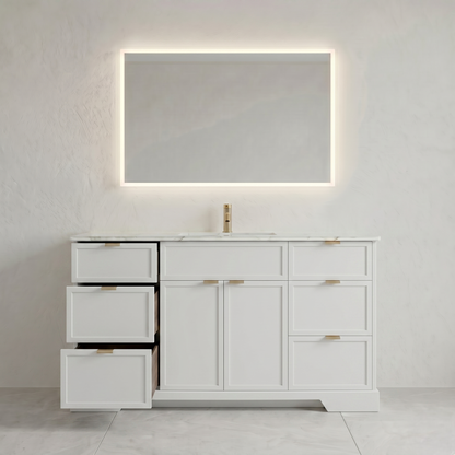 White bathroom vanity with mirror and faucet against a light gray wall.