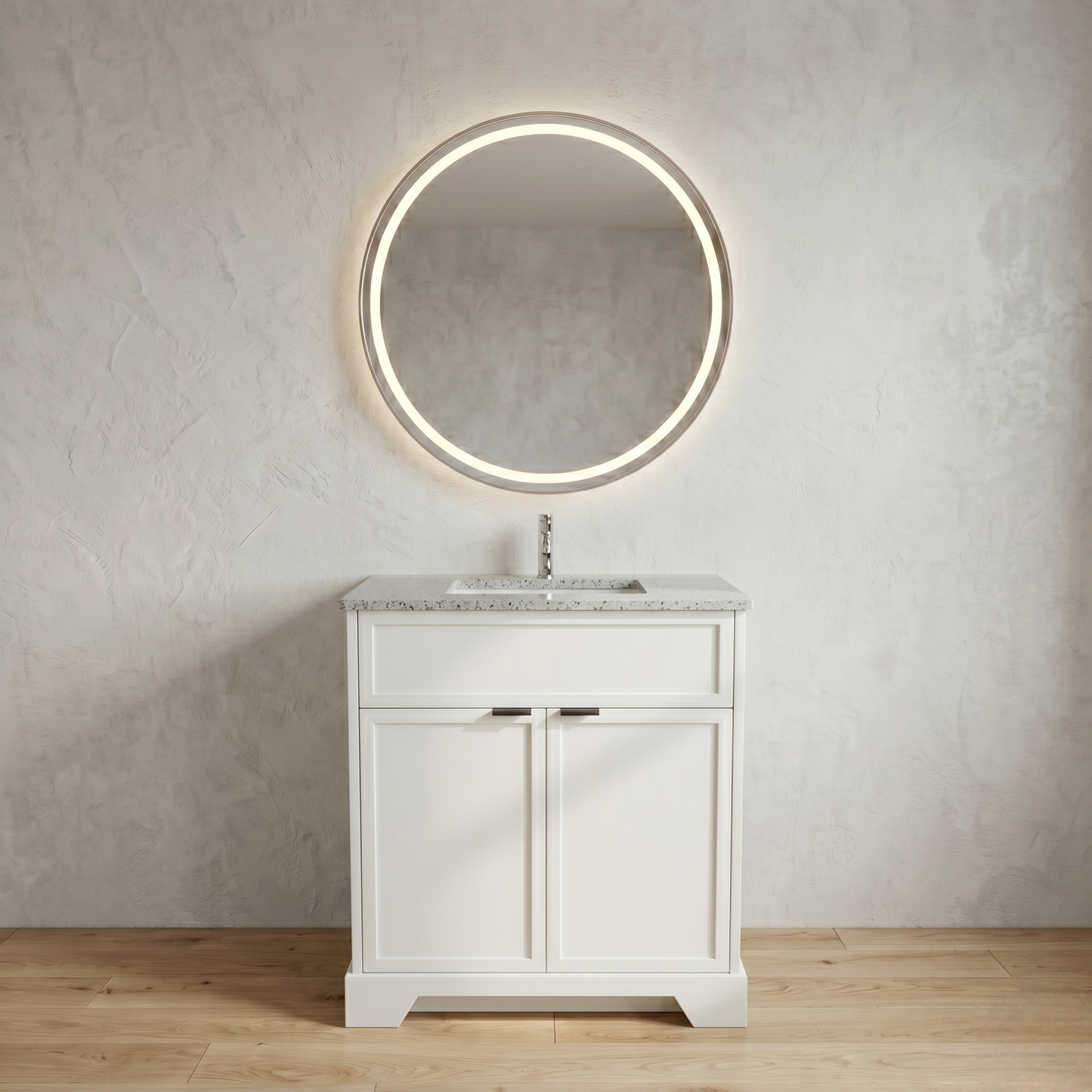 Bathroom vanity with round illuminated mirror against a neutral wall.