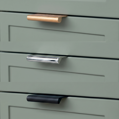 Green cabinet with three different colored handles on a light background