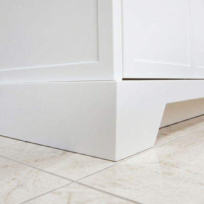 Close-up of a white cabinet corner with a marble floor.