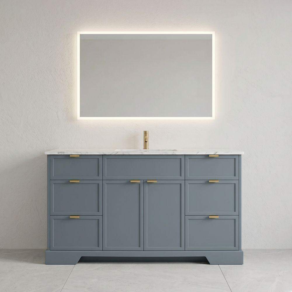 Gray bathroom vanity with marble countertop, gold fixtures, and illuminated mirror.